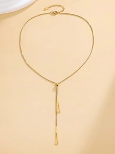 Detail view of golden adjustable Y-shaped necklace featuring dual geometric triangle pendants