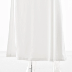 Detailed view of the smooth white dress hemline featuring clean stitching and quality fabric