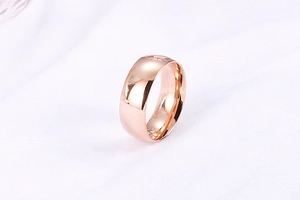 Detailed close-up of rose gold stainless steel ring with polished mirror finish surface