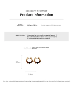 Detail view of gold-plated U-shaped earrings with brown tiger eye beads and silver pins