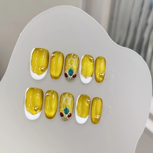 Golden cat eye press-on nails with hand-painted snake head and luxury rhinestones