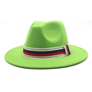 Detail of a bright green fedora hat featuring a stylish red and black patterned ribbon