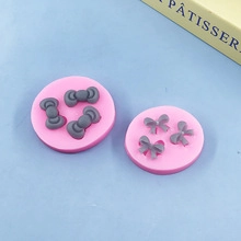Pink silicone molds showing Hello Kitty style bows and ribbon shapes for cake fondant