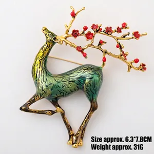 Macro shot of colorful enamel deer brooch with red plum blossoms and 6.3x7.8cm dimensions