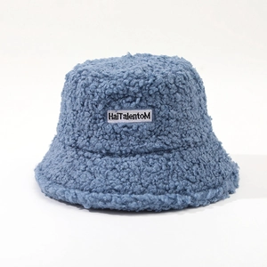 Detailed texture of blue plush faux shearling bucket hat with HaiTalentoM letter patch