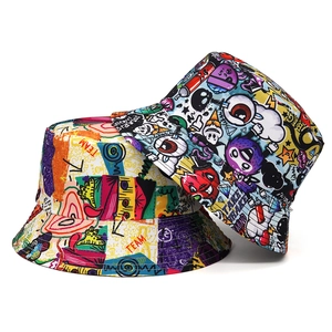 Detail of double-sided bucket hats with colorful graffiti prints and street style artwork