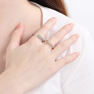 Sparkling silver and gold stainless steel rings with diamonds on a model's hand