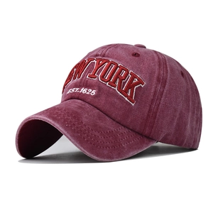 Vintage washed red baseball cap featuring detailed New York 1625 embroidery and curved brim