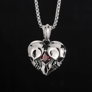 Punk silver heart necklace with skull design and red rhinestone pendant in a macro view