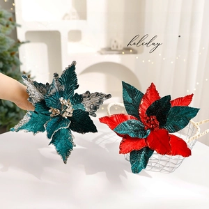 Green and red poinsettia Christmas flowers with glitter for tree decoration in a basket