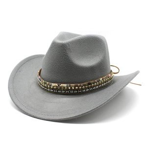 Detail view of a gray wool felt cowboy hat featuring ethnic woven band and gold beads