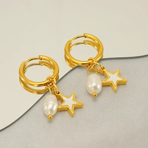 Gold stainless steel hoop earrings with white star and pearl charms on reflective surface