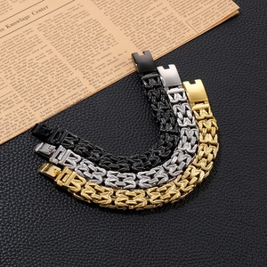 Detailed view of V-shaped hollow link chains in black, silver and gold stainless steel