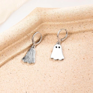 Close-up of cute white ghost pendants on silver alloy hoop earrings for festive parties
