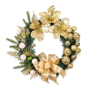 Golden and white Christmas wreath with pine needles, ornaments and a large satin bow