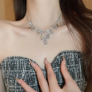 Elegant silver teardrop pendant necklace set worn by a model for a luxury fashion look