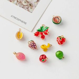 Macro shot of 18k gold plated mini fruit pendants with colorful enamel detailing