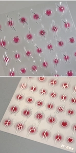 Macro shot of 3D embossed M-884 nail stickers with silver lines and red marble effect