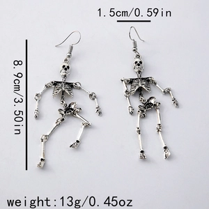 Detail view of silver skeleton earrings with mesh skirt and size measurements