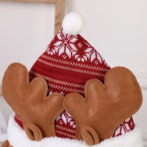 Red and white Christmas knit hat with brown reindeer antlers and a soft white pompom