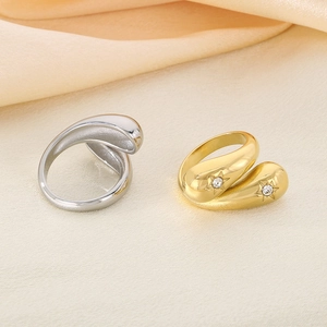 Irregular crossover stainless steel rings in gold and silver finish with crystal accents