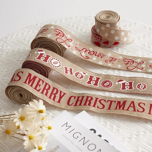 Rolls of printed burlap Christmas ribbons with festive patterns for DIY holiday decorations