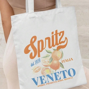 White canvas tote bag with vintage Spritz cocktail graphic worn over the shoulder