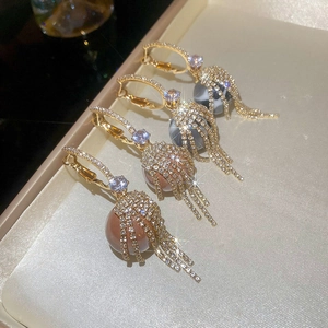 Sparkling zircon tassel sphere earrings in gold and marble texture for women