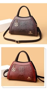 Detail of crocodile pattern leather handbags with gold hardware and kangaroo pendants