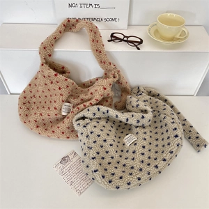 Detailed texture of plush polka dot tote bags in beige and blue on a minimal display