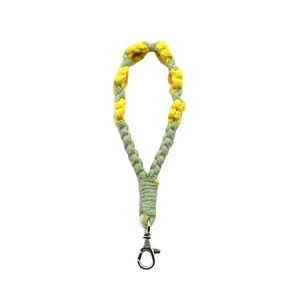 Handmade woven flower keychain with green and yellow cotton rope and silver metal clasp