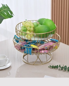 Close-up of a luxury two-tier golden metal fruit stand with marble texture trays