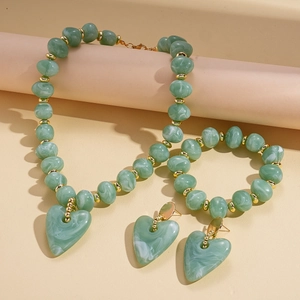 Detail of green marble beads and heart pendant on vintage necklace set