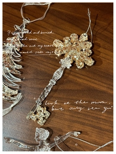 Detailed shot of acrylic Christmas tree, ballet girl and gold sequin key ornaments