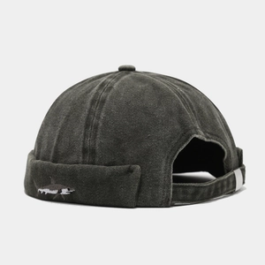 Detail view of washed cotton docker cap with shark embroidery and metal buckle