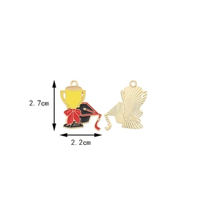 Macro view of a graduation trophy pendant with red enamel and gold finish details
