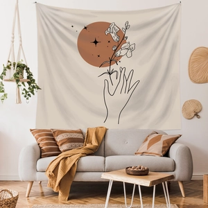 Morandi minimalist wall tapestry with hand and floral line art above a sofa in a modern room