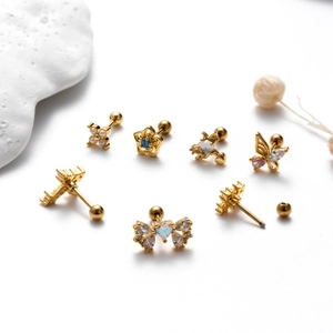 Golden stainless steel stud earrings with butterfly and zircon motifs on white background