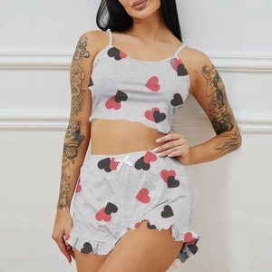 Women's pajama set featuring grey camisole crop top and ruffle shorts with heart patterns