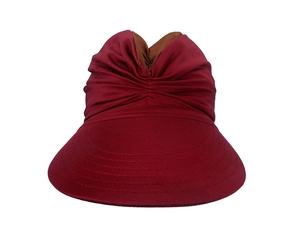 Detail of dark red sun hat with decorative pleated fabric and a stylish bow knot