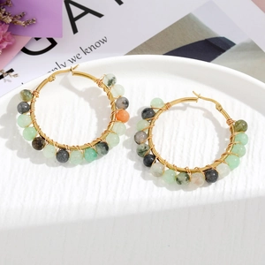 Detail of handmade wire-wrapped hoop earrings with colorful natural stone beads