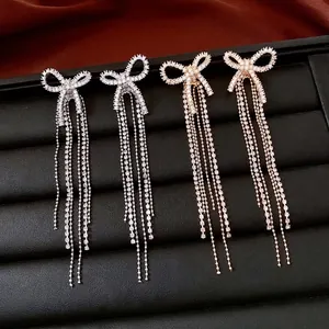 Elegant 18k gold plated bow knot tassel earrings featuring sparkly crystal fringe drops