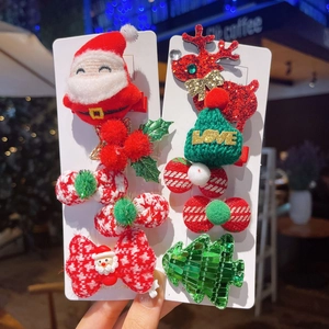 Detailed set of Christmas hair clips with plush Santa, reindeer, and festive bows