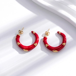 Elegant gold-tone C-shape hoop earrings with red enamel hearts in bohemian style