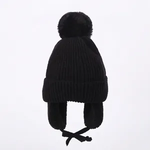 Winter knit baby earflap hat with pompom and warm fleece lining in solid black color
