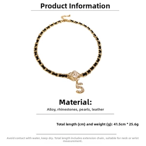 Detail view of woven leather chain necklace with pearl camellia flower and rhinestone number 5