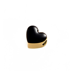 Detailed macro view of black enamel heart charm with gold metallic edges and hole for DIY jewelry