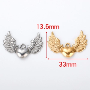 Macro detail of heart-shaped angel wing pendants in silver and gold finishes