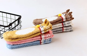 Close-up of fluffy coral fleece socks in multiple colors with cute 3D animal ears