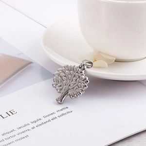 Silver tree of life pendant in stainless steel displayed on a minimalist white card